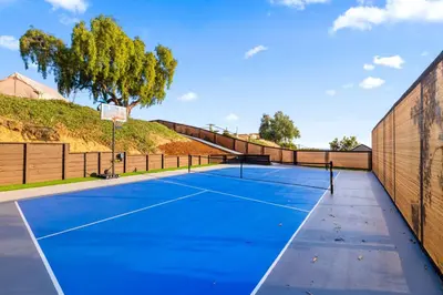 a tennis court with a basketball hoop on it at Bay Park Bliss Ocean Views Pickleball and Jacuzzi in San Diego