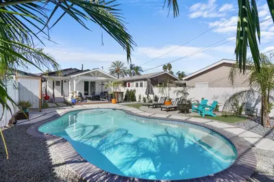 a swimming pool in a yard with a house at Renovated 3BR House with Heated Pool and Backyard Oasis in San Diego