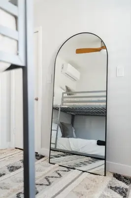 a mirror in a bedroom with a bed at Renovated 3BR House with Heated Pool and Backyard Oasis in San Diego