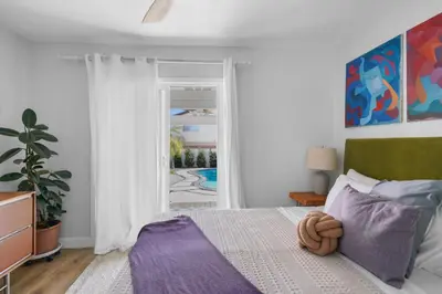 a bedroom with a bed and a sliding glass door at Renovated 3BR House with Heated Pool and Backyard Oasis in San Diego