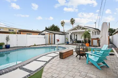 a swimming pool with a blue chair and a blue chair at Renovated 3BR House with Heated Pool and Backyard Oasis in San Diego