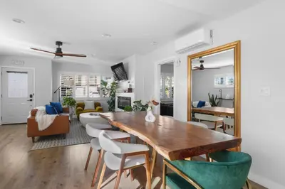 a dining room with a table and chairs and a living room at Renovated 3BR House with Heated Pool and Backyard Oasis in San Diego