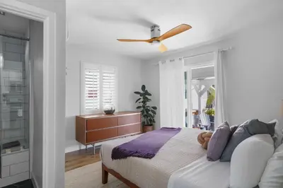 a bedroom with a bed and a ceiling fan at Renovated 3BR House with Heated Pool and Backyard Oasis in San Diego