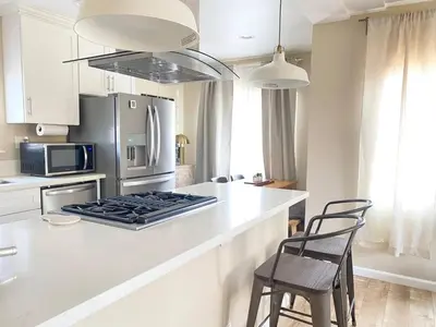 a kitchen with a stove and a refrigerator at Cozy Home in National City 15 min from San Diego in National City