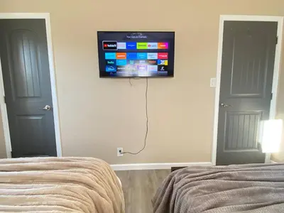 a bedroom with a flat screen tv on the wall at Cozy Home in National City 15 min from San Diego in National City