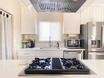 a kitchen with a stove top oven in a kitchen at Cozy Home in National City 15 min from San Diego in National City