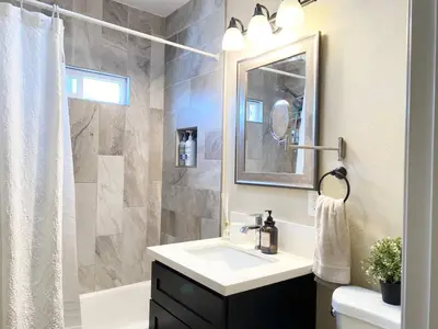 a bathroom with a white sink and a shower at Cozy Home in National City 15 min from San Diego in National City