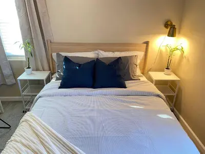a large bed with blue pillows in a bedroom at Cozy Home in National City 15 min from San Diego in National City