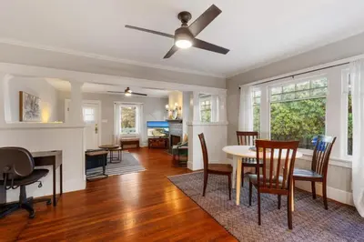 a living room with a ceiling fan and a table and chairs at Stylish 2BR Home and Studio Great Central Location in San Diego