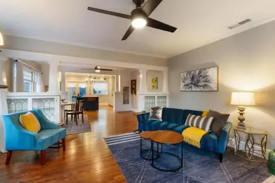 a living room with a blue couch and a table at Stylish 2BR Home and Studio Great Central Location in San Diego