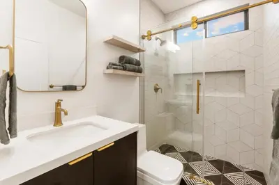 a white bathroom with a sink and a toilet at Stylish 2BR Home and Studio Great Central Location in San Diego