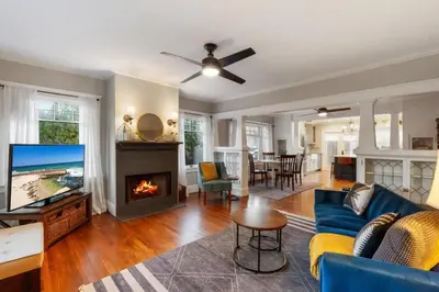 a living room with a blue couch and a fireplace at Stylish 2BR Home and Studio Great Central Location in San Diego