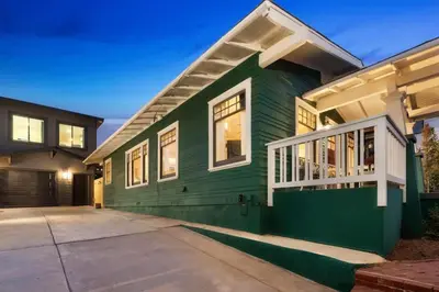 a green house with a garage at Stylish 2BR Home and Studio Great Central Location in San Diego