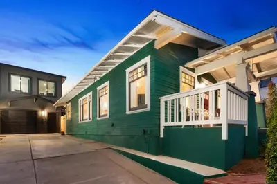 a green house with a white porch at Stylish 2BR Home and Studio Great Central Location in San Diego