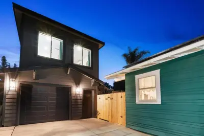 a house with a garage and a green building at Stylish 2BR Home and Studio Great Central Location in San Diego
