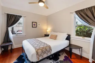 a bedroom with a bed and two windows at Stylish 2BR Home and Studio Great Central Location in San Diego