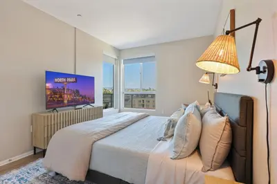 a bedroom with a large bed and a large window at North Park Modern 2BR King Beds, Workspaces, Parking in San Diego