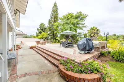 a patio with a table and an umbrella at 3Bed Single Level Home in Carlsbad