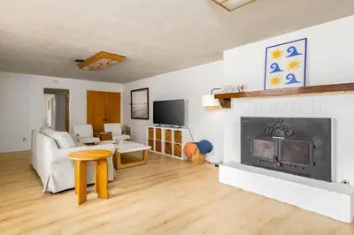 a living room with a fireplace and a couch at Spacious 2 Bed in Carlsbad in Carlsbad