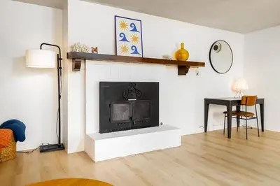 a living room with a fireplace and a table at Spacious 2 Bed in Carlsbad in Carlsbad