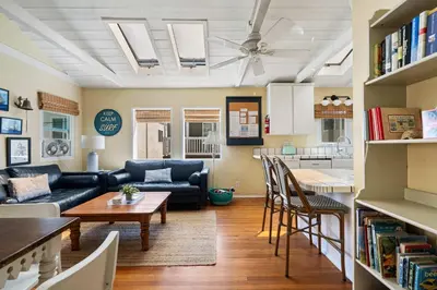 a living room with a couch and a table at Cute Home Steps from the Sand in San Diego