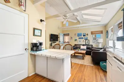 a kitchen and living room with a living room at Cute Home Steps from the Sand in San Diego