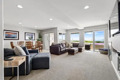 a living room with a couch and a table at Blue Horizon - SUR67 in Solana Beach