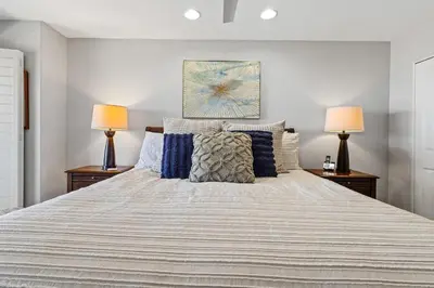 a bedroom with a large bed with two lamps at Blue Horizon - SUR67 in Solana Beach