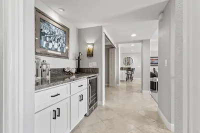 a kitchen with white cabinets and a dining room at Blue Horizon - SUR67 in Solana Beach