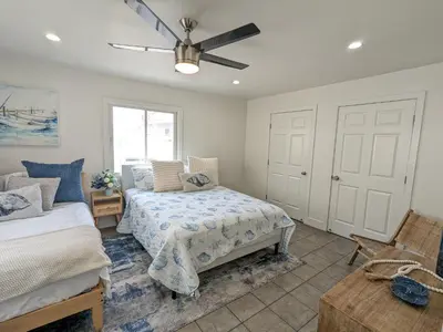 a bedroom with two beds and a ceiling fan at Steps from Ocean! Ocean and Bay Views! Rooftop Deck! Two-Car Garage! Renovated! in San Diego