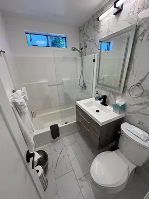 a bathroom with a toilet and a sink and a shower at BBQ Grill 5 mins to DT Canyon Views Parking in San Diego