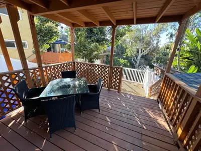 a patio with a table and chairs on a deck at BBQ Grill 5 mins to DT Canyon Views Parking in San Diego