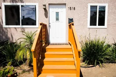 a set of stairs leading to a white door at BBQ Grill 5 mins to DT Canyon Views Parking in San Diego
