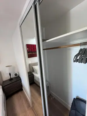 a mirror in a room with a bed and a bedroom at BBQ Grill 5 mins to DT Canyon Views Parking in San Diego