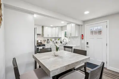 a kitchen and dining room with a table and chairs at Designer Home with Yard -Walk to Beach, Shops and More in Solana Beach