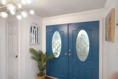 a blue door in a room with a potted plant at Irvine Lake Forest Lake and Boat in Lake Forest