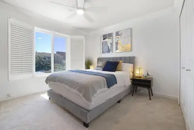 a white bedroom with a bed and a window at Irvine Lake Forest Lake and Boat in Lake Forest