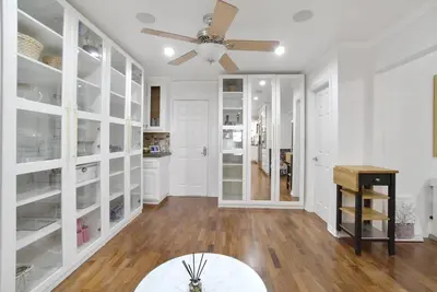 a living room with white cabinets and a ceiling fan at Irvine Lake Forest Lake and Boat in Lake Forest