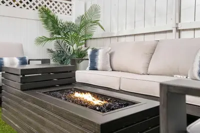 a living room with a couch and a fire pit at La Jolla Beach Villa - Walk to Windansea Beach in San Diego