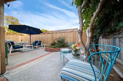a patio with chairs and a table and an umbrella at Cozy La Jolla Bungalow Near Beach & Village in San Diego