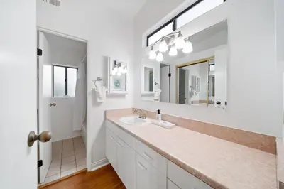 a bathroom with a sink and a mirror at Cozy La Jolla Bungalow Near Beach & Village in San Diego