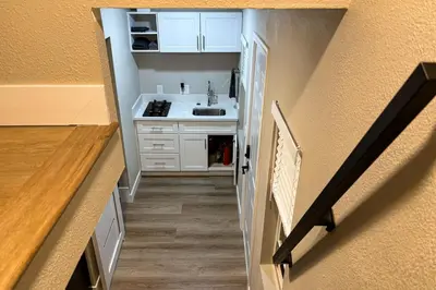 a small kitchen with a sink and a hallway at Pool and Hot Tub Access Cozy Perris Tiny Home in Perris