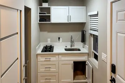 a small kitchen with a sink and a stove at Pool and Hot Tub Access Cozy Perris Tiny Home in Perris