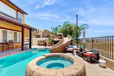 a backyard with a plunge pool and a slide at Pool and Hot Tub Access Cozy Perris Tiny Home in Perris