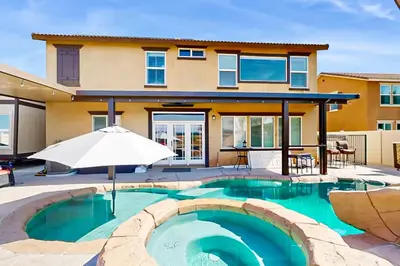 a swimming pool in front of a house at Pool and Hot Tub Access Cozy Perris Tiny Home in Perris