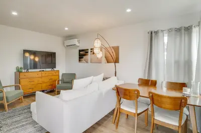 a living room with a white couch and a table at Hip Walkable Neighborhood Condo in San Diego in San Diego