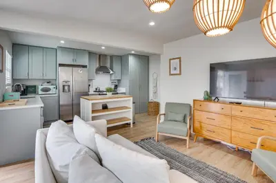 a living room with a couch and a kitchen at Hip Walkable Neighborhood Condo in San Diego in San Diego