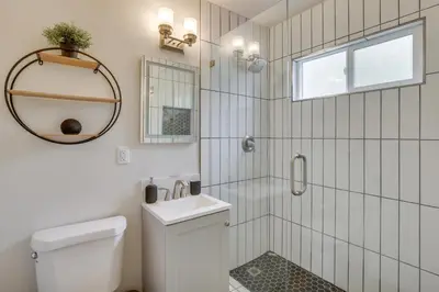a bathroom with a toilet and a sink and a shower at Hip Walkable Neighborhood Condo in San Diego in San Diego