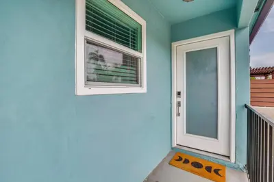 a blue house with a door and a window at Hip Walkable Neighborhood Condo in San Diego in San Diego