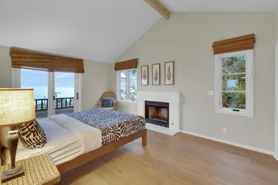 a bedroom with a bed and a fireplace at Fairway Retreat, Stylish Coastal Home Near Golf, Beaches & Carlsbad Fun in Encinitas